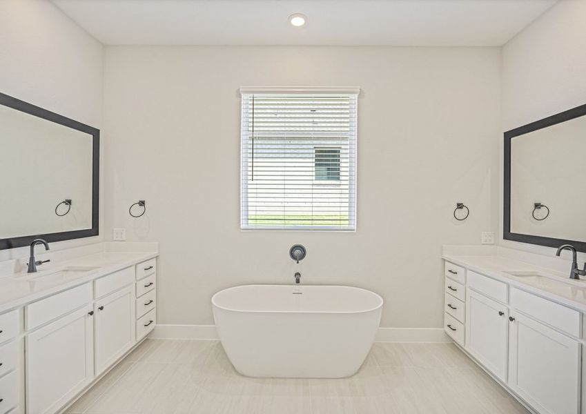 The master bathroom has two sprawling vanities and a stand-alone tub. The master bathroom has two sprawling vanities and a stand-alone tub.