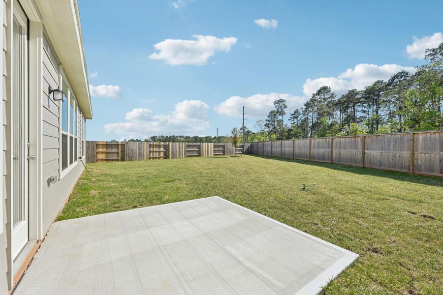 View of the backyard green space, fully fenced.