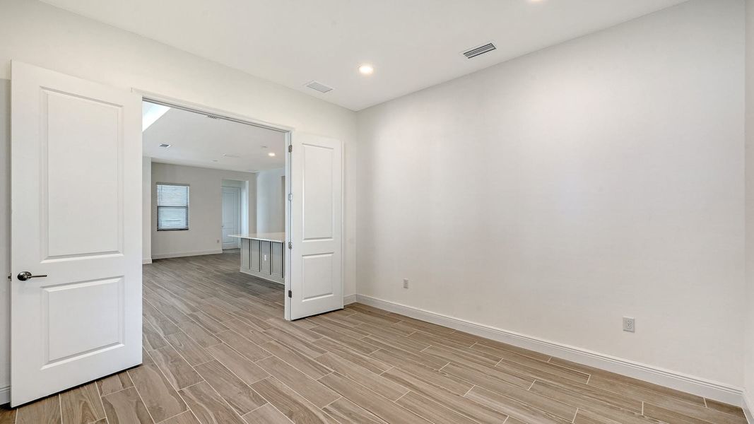 Spacious, unfurnished interior of a new home in Palm Grove Real Estate and Homes for Sale in Lakewood Ranch, FL - Neal Communities, Bradenton (Image 24).
