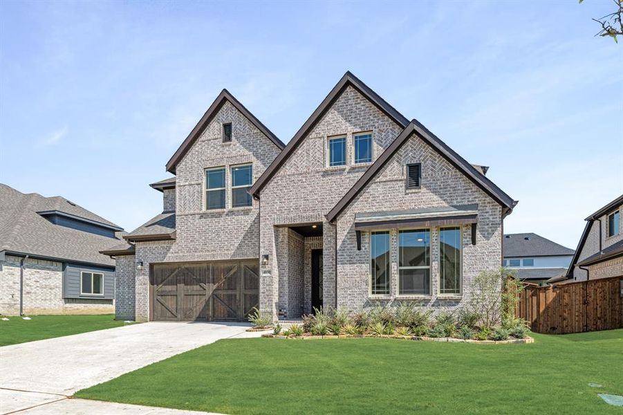 Front exterior of a new home in Windsong Ranch Classic 61, Prosper, TX, highlighting curb appeal (Image 2). Front exterior of a new home in Windsong Ranch Classic 61, Prosper, TX, highlighting curb appeal (Image 2).