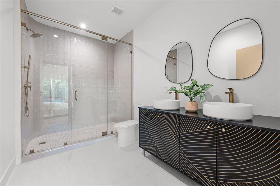 Full bath with a shower stall and double vanity