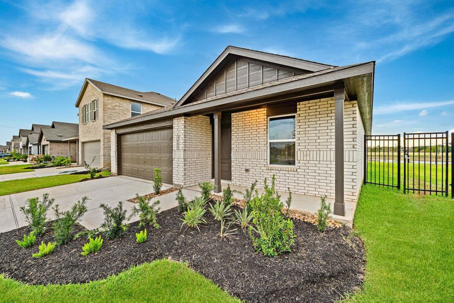 Front exterior of a new home in Sunterra, Katy, TX, highlighting curb appeal (Image 15). Front exterior of a new home in Sunterra, Katy, TX, highlighting curb appeal (Image 15).