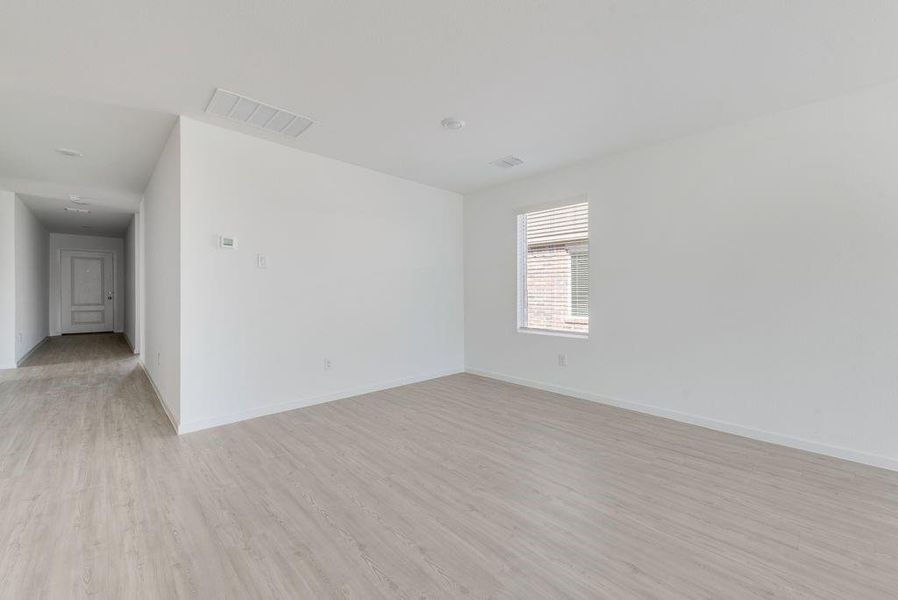 Unfurnished room with light wood-type flooring and baseboards