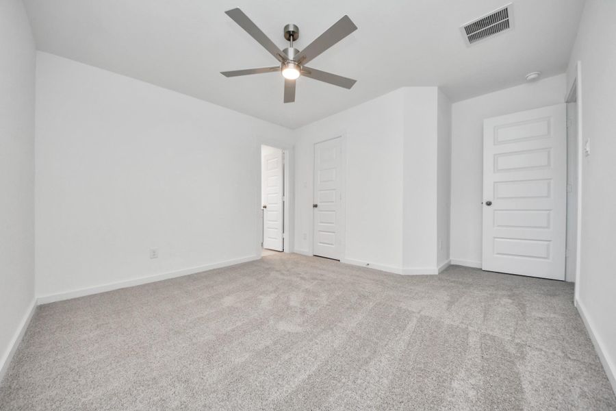 Secondary bedroom features plush carpeting, large windows that let in plenty of natural light, bright paint, and spacious closets. Sample photo of completed home with similar floor plan. Actual colors and selections may vary. Secondary bedroom features plush carpeting, large windows that let in plenty of natural light, bright paint, and spacious closets. Sample photo of completed home with similar floor plan. Actual colors and selections may vary.
