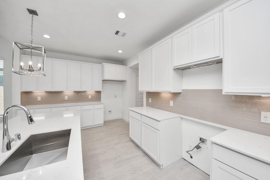 The extended counter area adds both practicality and style, making meal preparation a breeze. Every detail is thoughtfully designed to enhance the kitchen's functionality and aesthetic appeal. Sample photo of completed home with similar floor plan. Actual colors and selections may vary. The extended counter area adds both practicality and style, making meal preparation a breeze. Every detail is thoughtfully designed to enhance the kitchen's functionality and aesthetic appeal. Sample photo of completed home with similar floor plan. Actual colors and selections may vary.