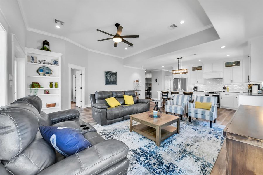 Living room looking towards the primary bedroom and kitchen