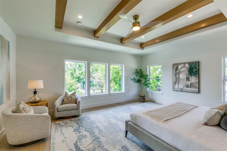 Bedroom featuring light hardwood / wood-style floors, beam ceiling, and ceiling fan