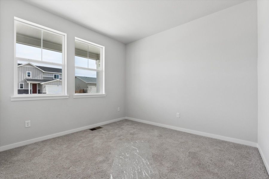 A room with a window and a carpet. A room with a window and a carpet.