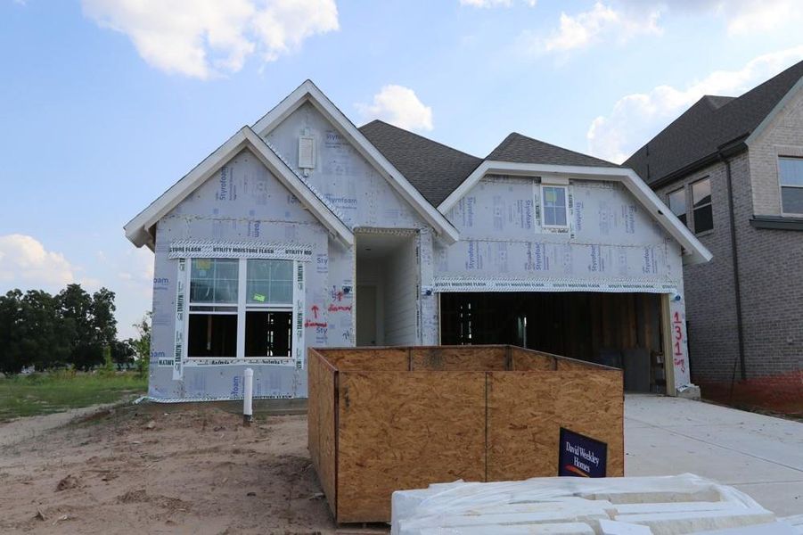 Front exterior of a new home in Harvest Green 45', Richmond, TX, highlighting curb appeal (Image 2).