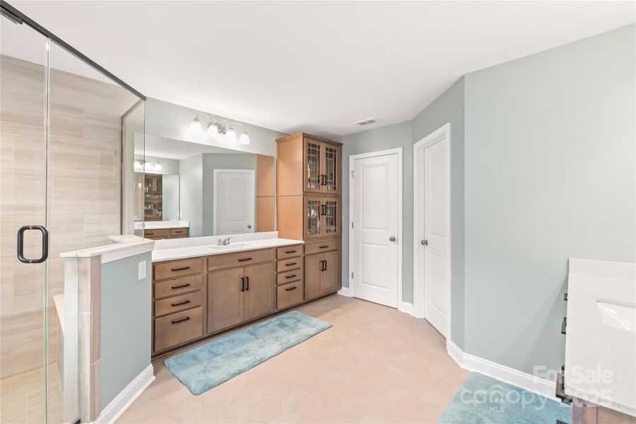 Upgraded cabinetry with picture frame glass fronts Upgraded cabinetry with picture frame glass fronts