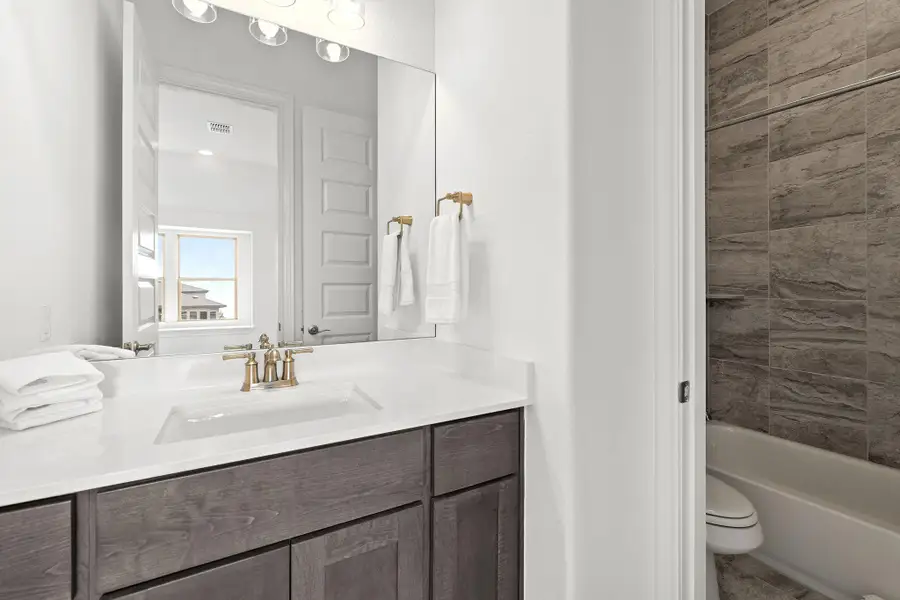 Bathroom featuring vanity and shower / bathtub combination