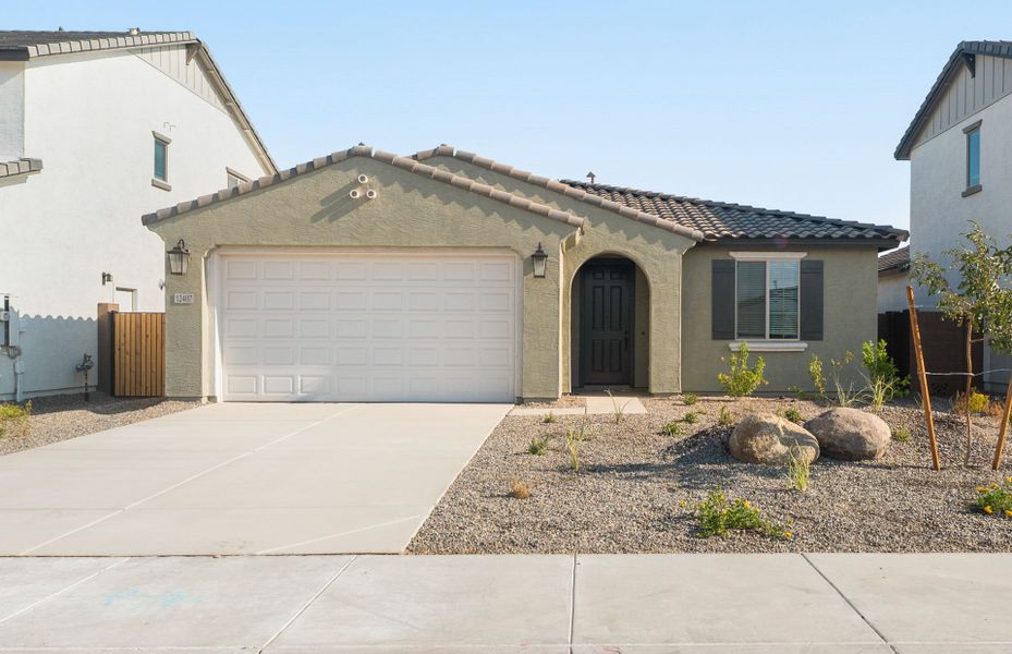 Front exterior of a new home in Alamar, Avondale, AZ, highlighting curb appeal (Image 2). Front exterior of a new home in Alamar, Avondale, AZ, highlighting curb appeal (Image 2).