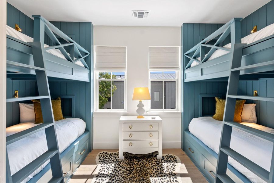 Twin bunk beds with integrated storage and accent lighting define this vibrant sleeping area. Twin bunk beds with integrated storage and accent lighting define this vibrant sleeping area.