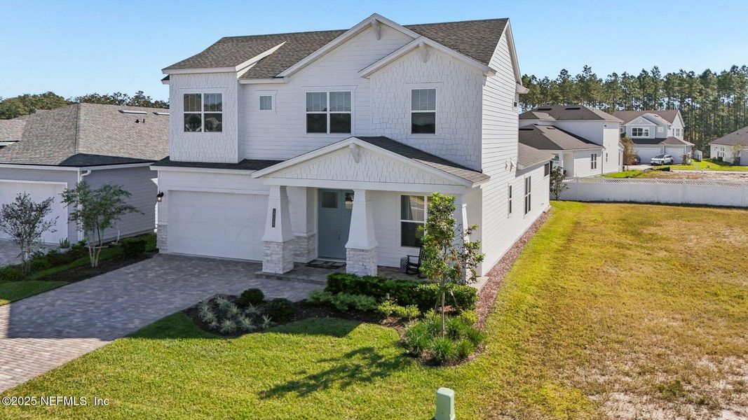 Front exterior of a new home in Courtney Chase, St. Augustine, FL, highlighting curb appeal (Image 26). Front exterior of a new home in Courtney Chase, St. Augustine, FL, highlighting curb appeal (Image 26).