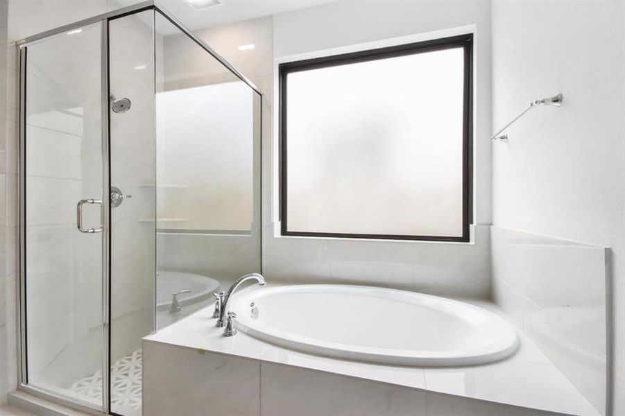 **REPRESENTATIVE IMAGE**Luxurious ensuite bathroom with a relaxing soaking tub and glass surrounding shower.