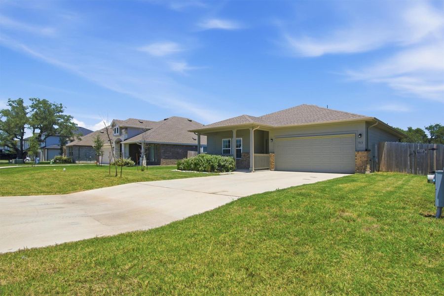 A well-maintained lawn welcomes you to this inviting residence with an attached garage.