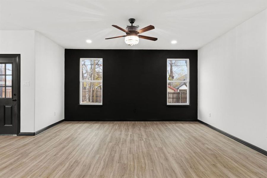 Living room featuring ceiling fan, plenty of natural light, and light wood-type flooring