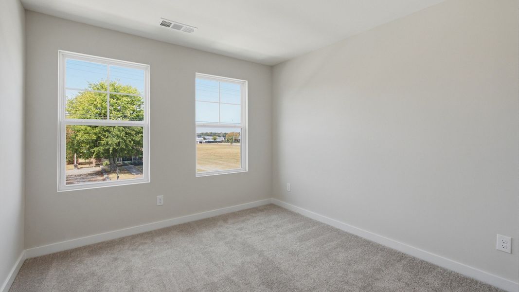 Secondary bedroom with upstairs view of community
