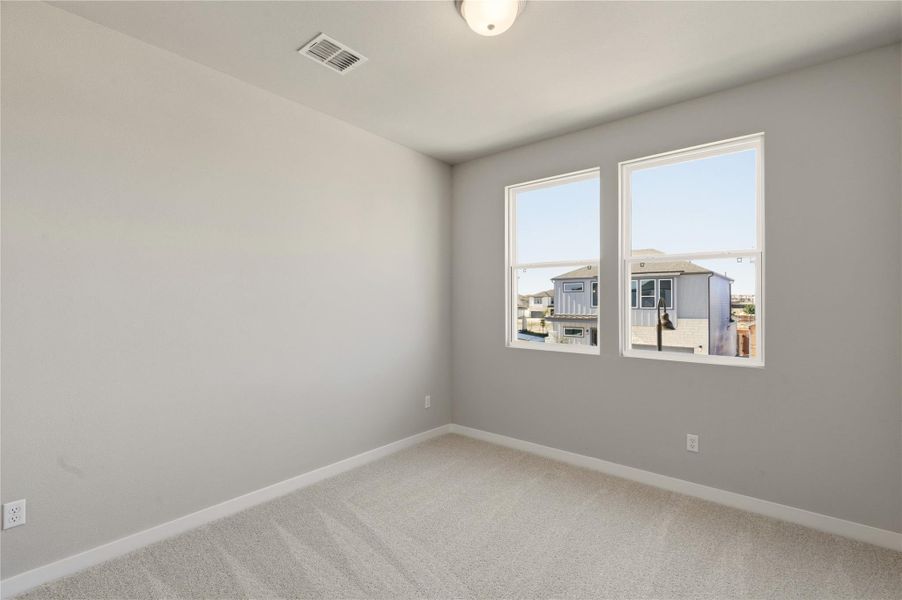 Carpeted empty room featuring baseboards