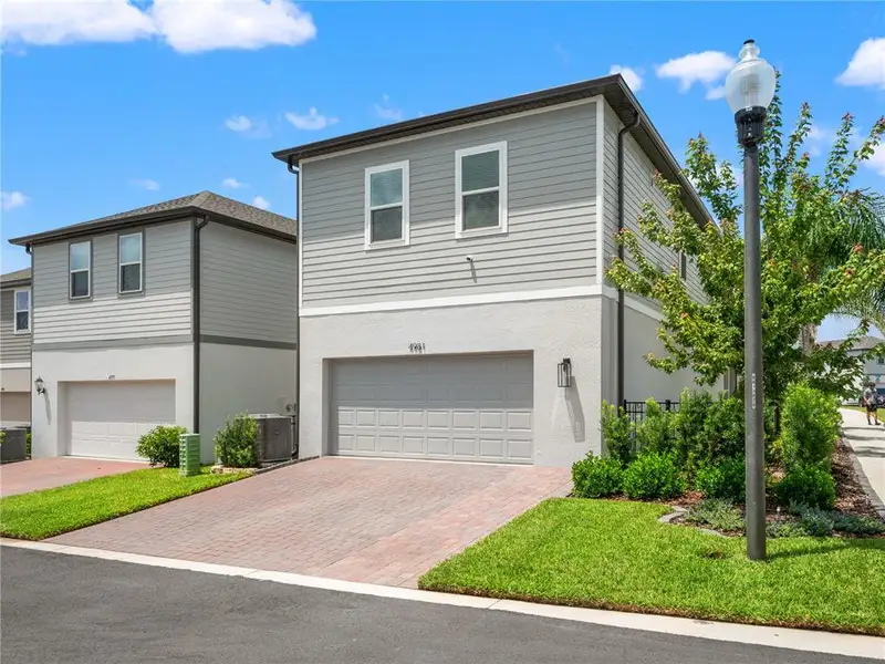 Front exterior of a new home in , Winter Garden, FL, highlighting curb appeal (Image 26).