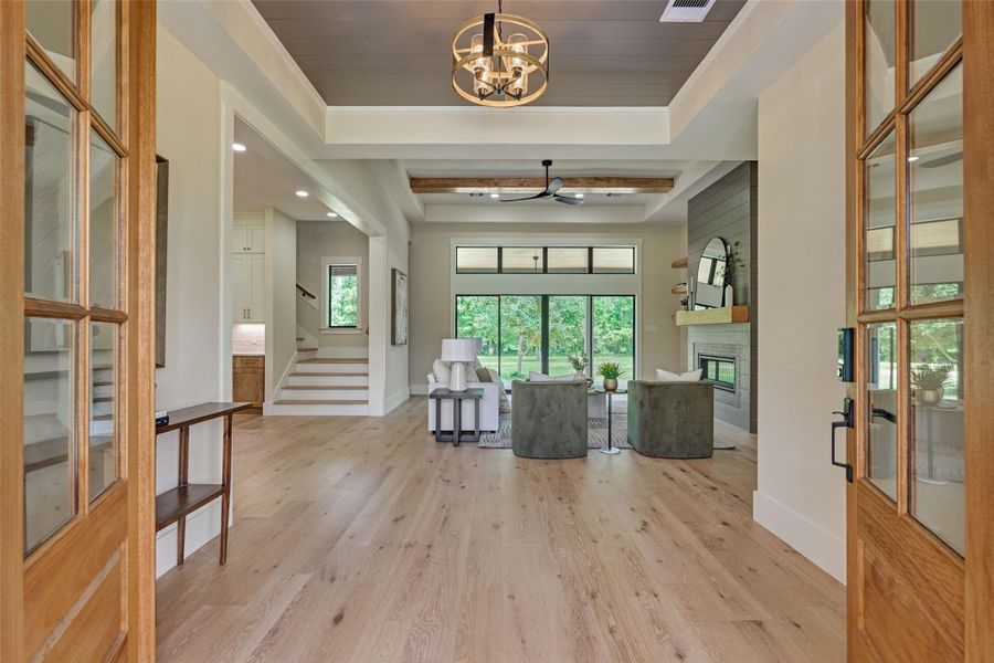 An introduction to elegance — soaring ceilings, warm wood tones, and sightlines that stretch straight through to your own private backyard retreat. The first impression here is the one that stays with you. An introduction to elegance — soaring ceilings, warm wood tones, and sightlines that stretch straight through to your own private backyard retreat. The first impression here is the one that stays with you.