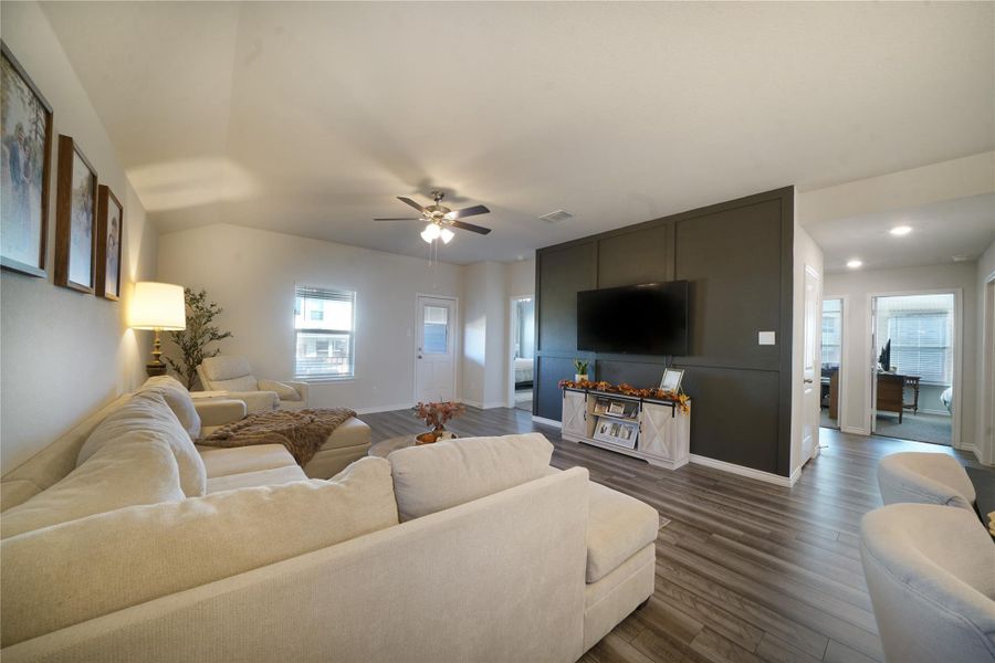 Living room with dark wood-style floors and ceiling fan