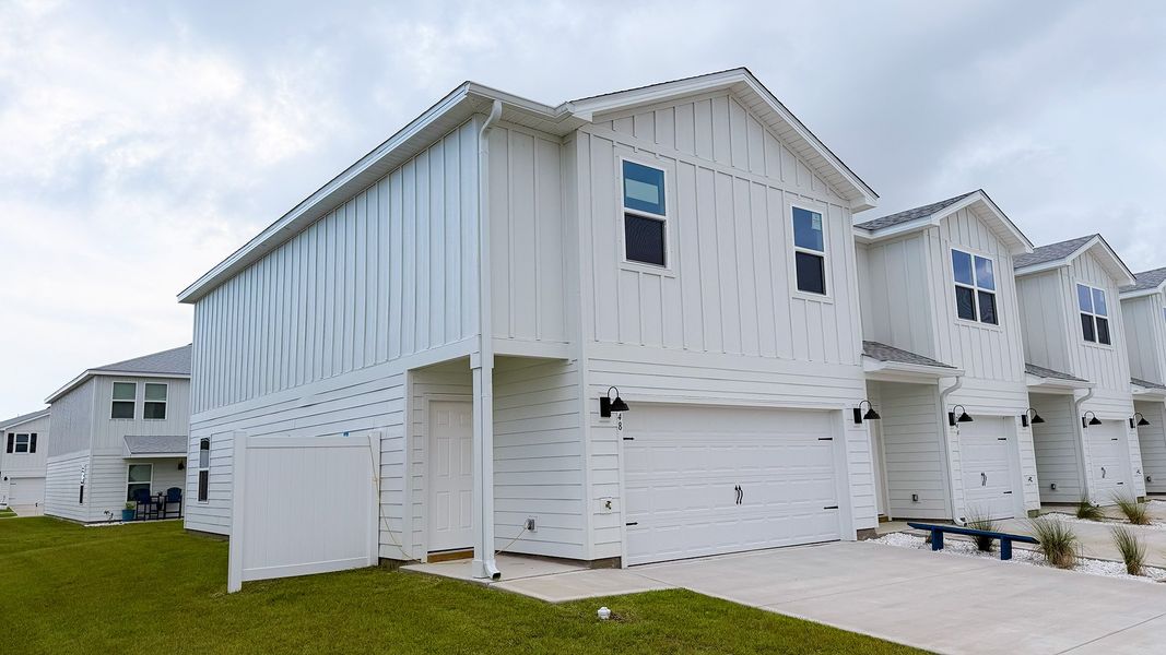 Front exterior of a new home in Salt Creek Townhomes at Mexico Beach, Mexico Beach, FL, highlighting curb appeal (Image 2). Front exterior of a new home in Salt Creek Townhomes at Mexico Beach, Mexico Beach, FL, highlighting curb appeal (Image 2).