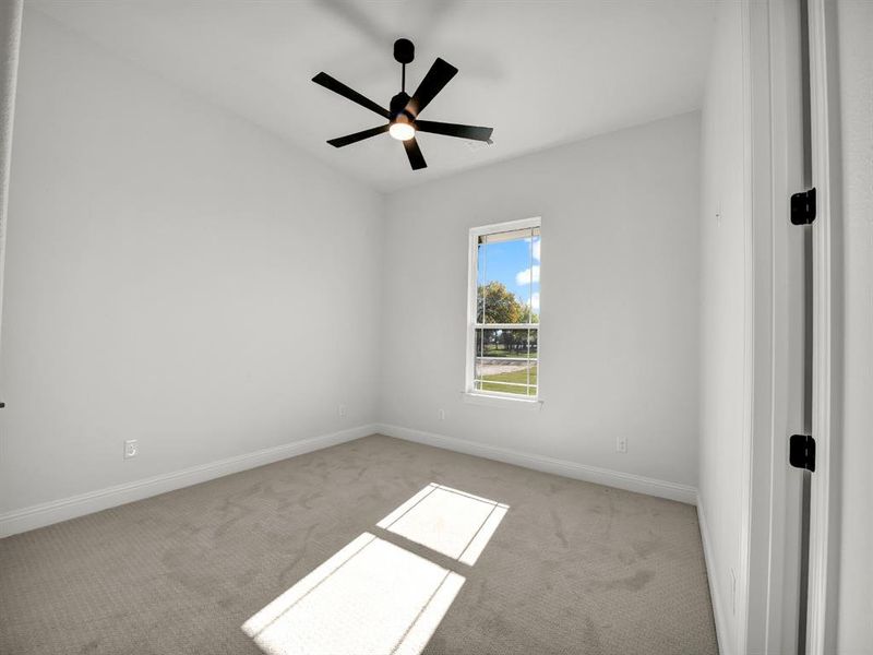 Unfurnished room featuring light colored carpet and ceiling fan