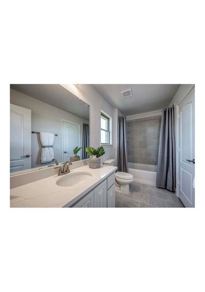 Full bathroom with toilet, shower / bath combination with curtain, vanity, and tile patterned floors