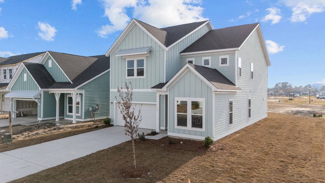 Front exterior of a new home in Blue Heron Retreat: Oasis Series, Little River, SC, highlighting curb appeal (Image 17). Front exterior of a new home in Blue Heron Retreat: Oasis Series, Little River, SC, highlighting curb appeal (Image 17).