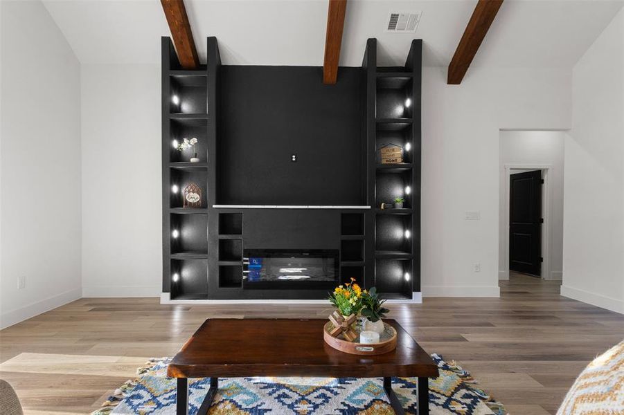 Living area with light wood-style flooring and a fireplace
