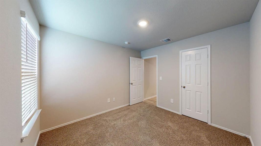 Unfurnished bedroom featuring carpet floors and baseboards