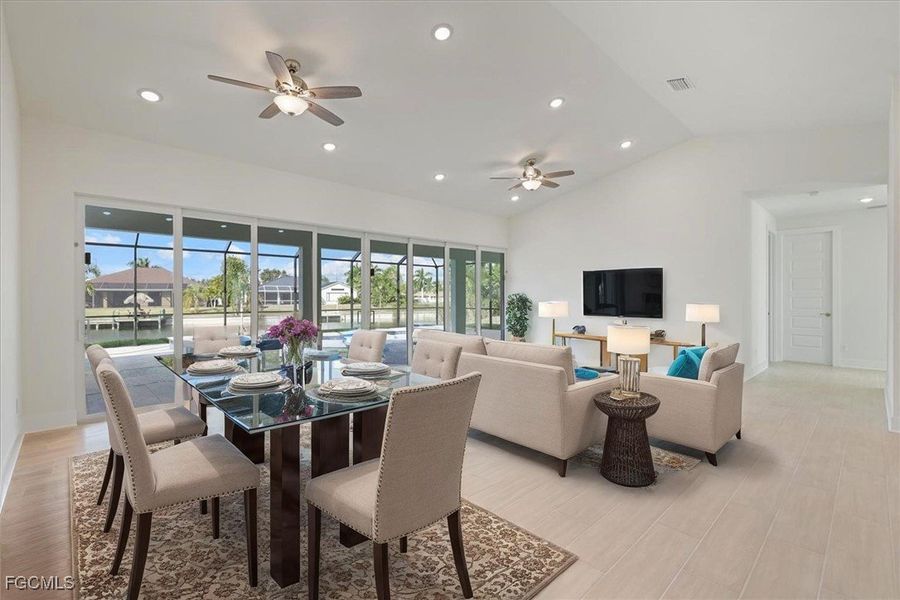 Dining room featuring recessed lighting, light wood-type flooring, a ceiling fan, and vaulted ceiling