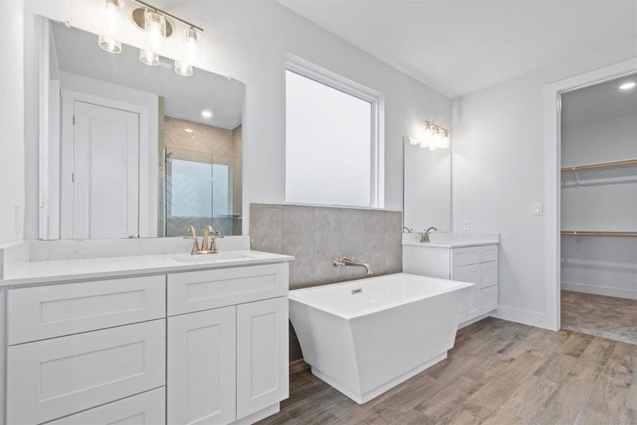 Bathroom featuring vanity and plus walk in shower