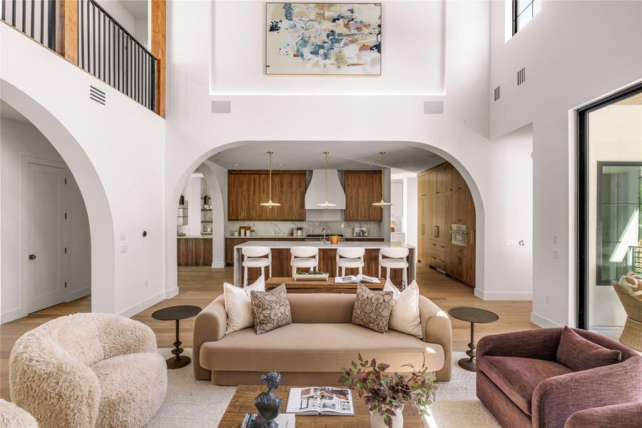 Elegant open concept living and kitchen areas feature soaring ceilings and natural wood finishes.