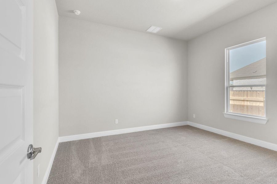 Carpeted spare room featuring baseboards Carpeted spare room featuring baseboards