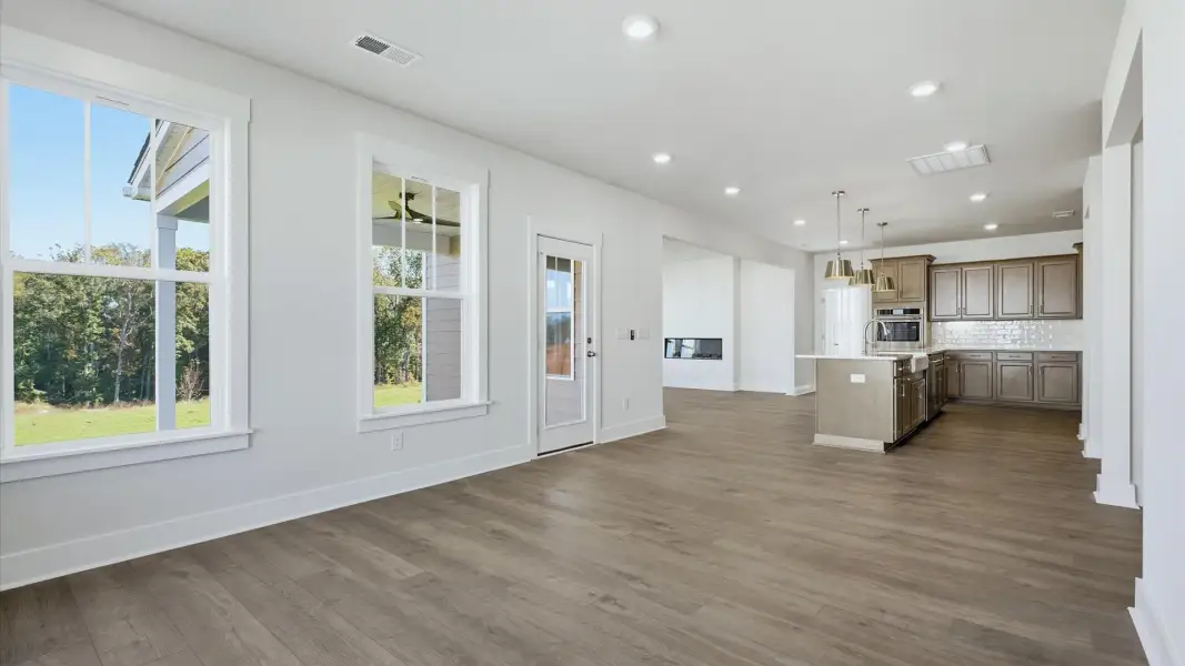 Spacious breakfast area with rich hardwood flooring and elegant trim work in a reputable DRB Homes build Spacious breakfast area with rich hardwood flooring and elegant trim work in a reputable DRB Homes build