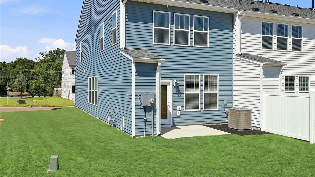Refined rear exterior with a stylish patio for dining, relaxing, or entertaining by DRB Homes Refined rear exterior with a stylish patio for dining, relaxing, or entertaining by DRB Homes