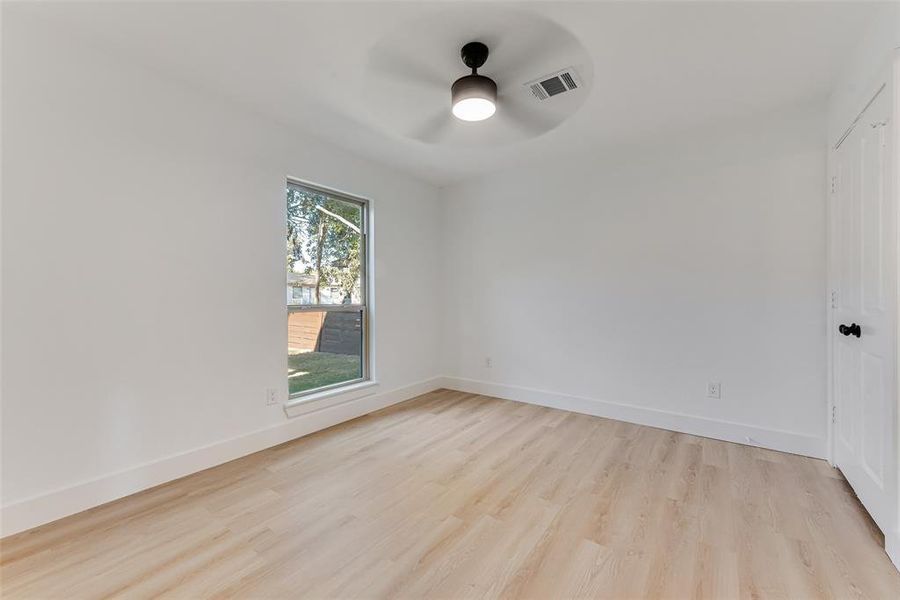 Unfurnished room featuring light hardwood / wood-style floors and ceiling fan