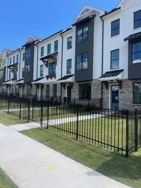 Front exterior of a new home in Palisades Townhomes, Cumming, GA, highlighting curb appeal (Image 18).
