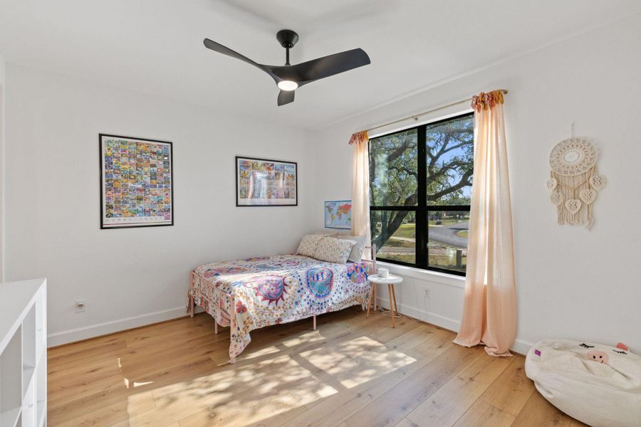 Bedroom featuring light wood finished floors and a ceiling fan