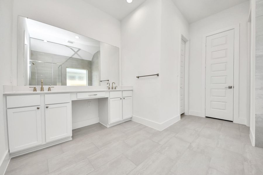 Escape to a spa-like oasis in this primary bathroom. Enjoy a walk-in shower with tile surround, a separate garden tub with custom detailing, and an elegant vanity featuring light countertops, modern hardware, and beautiful recessed lights. Experience luxury and relaxation in every detail. Escape to a spa-like oasis in this primary bathroom. Enjoy a walk-in shower with tile surround, a separate garden tub with custom detailing, and an elegant vanity featuring light countertops, modern hardware, and beautiful recessed lights. Experience luxury and relaxation in every detail.