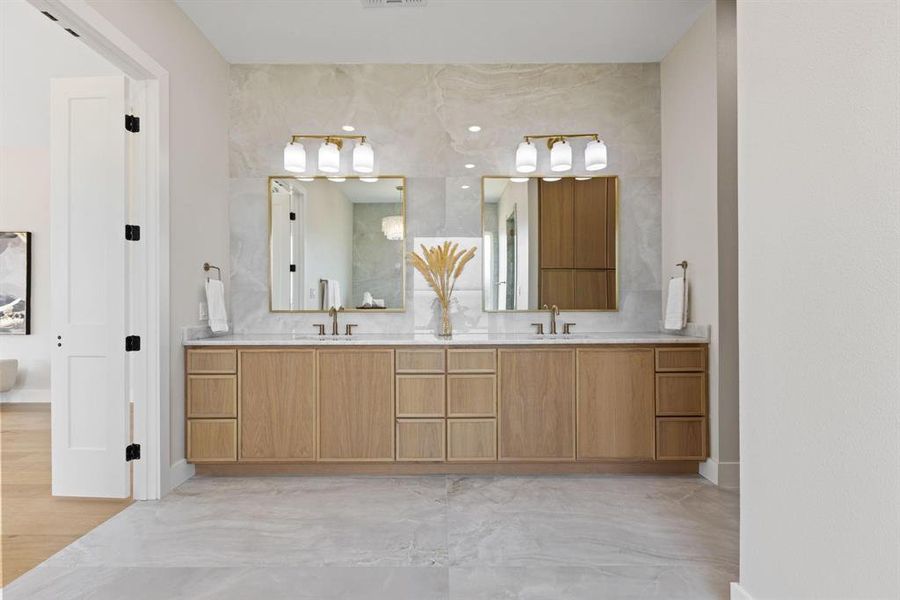 Bathroom with double vanity and baseboards Bathroom with double vanity and baseboards