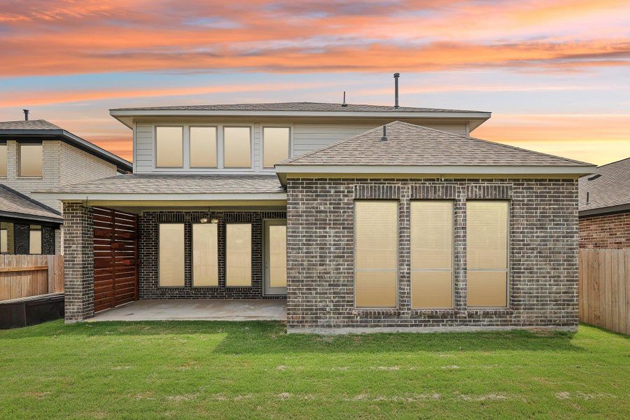 Rear view of property featuring a patio area, roof with shingles, and brick siding Rear view of property featuring a patio area, roof with shingles, and brick siding