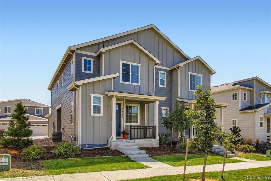 Front exterior of a new home in Haskins Station, Arvada, CO, highlighting curb appeal (Image 24).