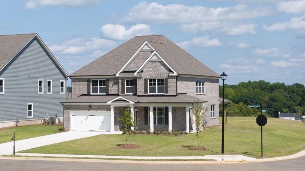 Front exterior of a new home in Thalley Creek Estates, Cumming, GA, highlighting curb appeal (Image 2). Front exterior of a new home in Thalley Creek Estates, Cumming, GA, highlighting curb appeal (Image 2).