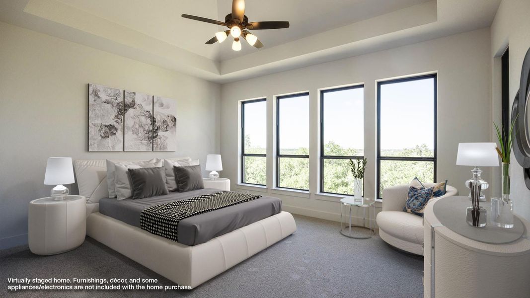 Carpeted bedroom with a raised ceiling and a ceiling fan Carpeted bedroom with a raised ceiling and a ceiling fan