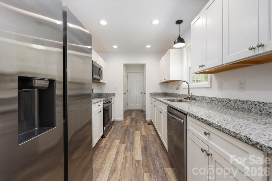 Kitchen with granite countertops with stainless appliances