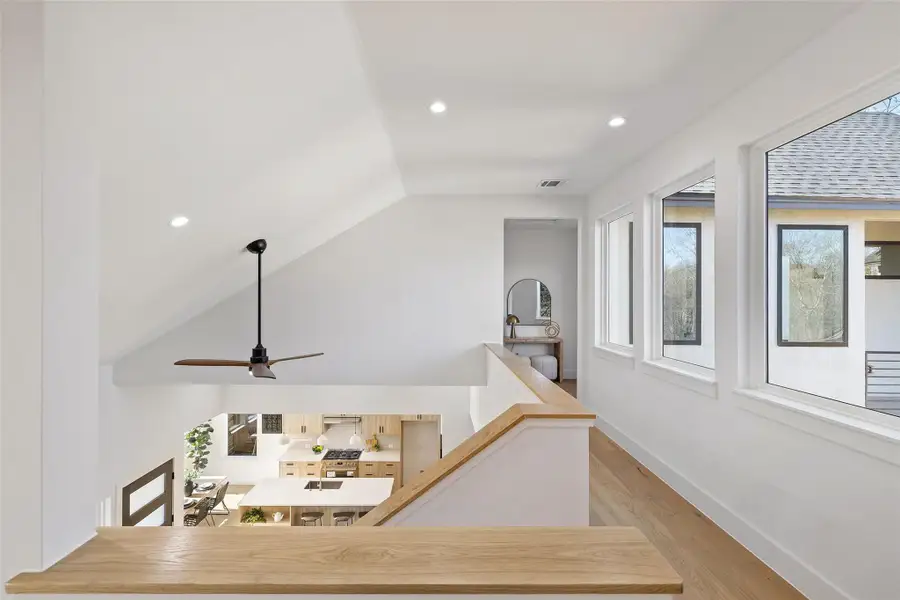 Interior space with hardwood / wood-style flooring, lofted ceiling, and plenty of natural light