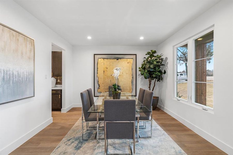 Dining room with a healthy amount of sunlight and light hardwood / wood-style flooring